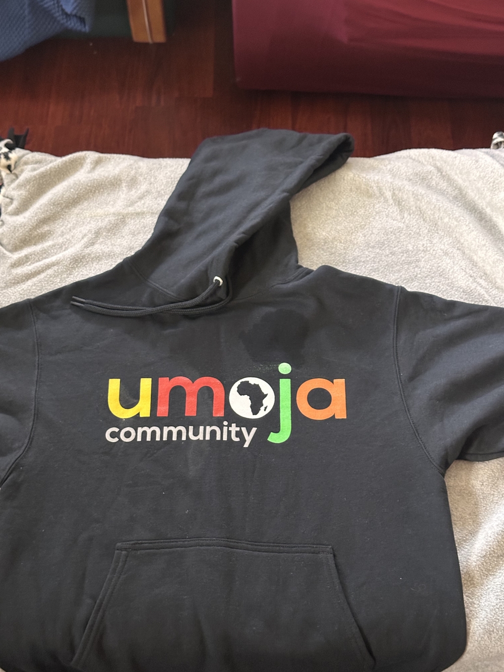 Umoja Community Black Hoodie with Multicolor Logo